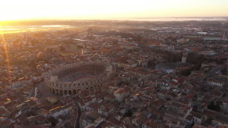 Aerial-back-traveling-over-Arles-amphitheatre-arena-France-sunrise
